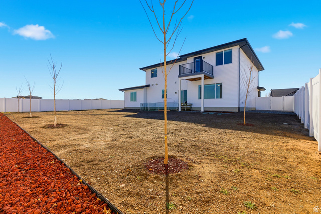 3902 West 825 North West Point, UT 84015 - Photo 33 of 49 Back of house with a fenced backyard and a balcony