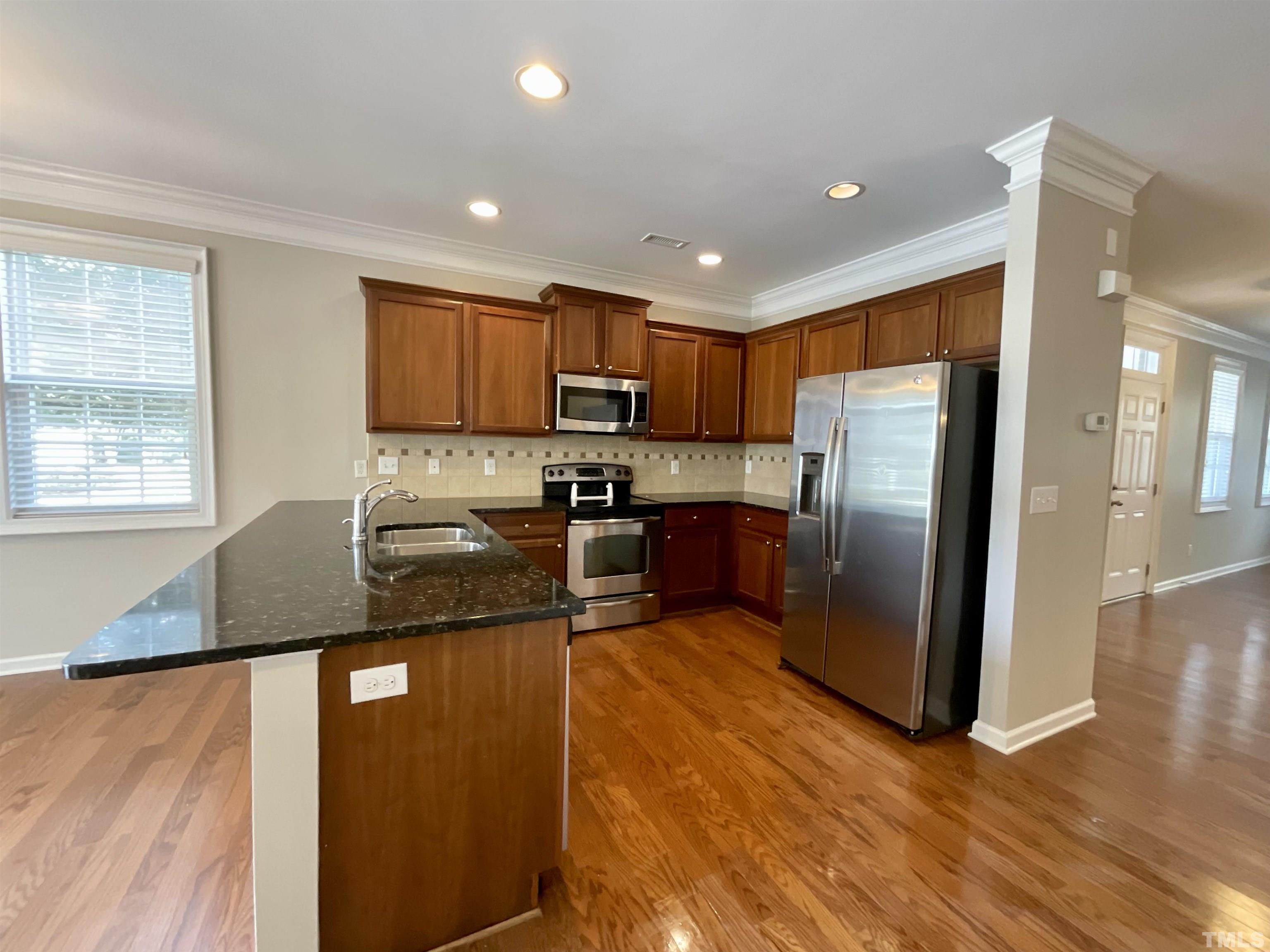 2632 Cloud Mist Circle Raleigh, NC 27614 - Photo 12 of 25 a kitchen with granite countertop a refrigerator and a stove top oven
