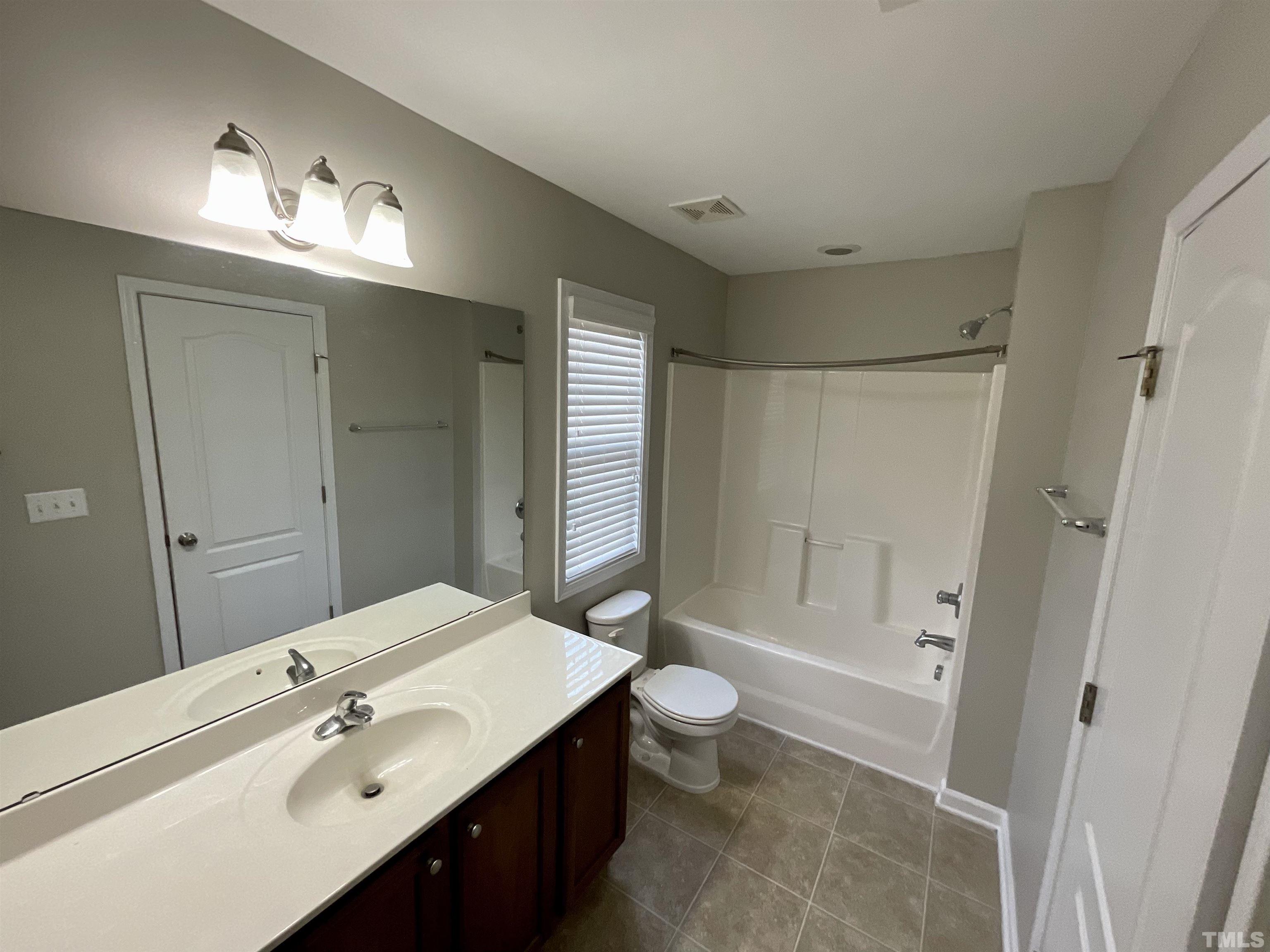 2632 Cloud Mist Circle Raleigh, NC 27614 - Photo 16 of 25 a spacious bathroom with a bathtub shower sink mirror and toilet