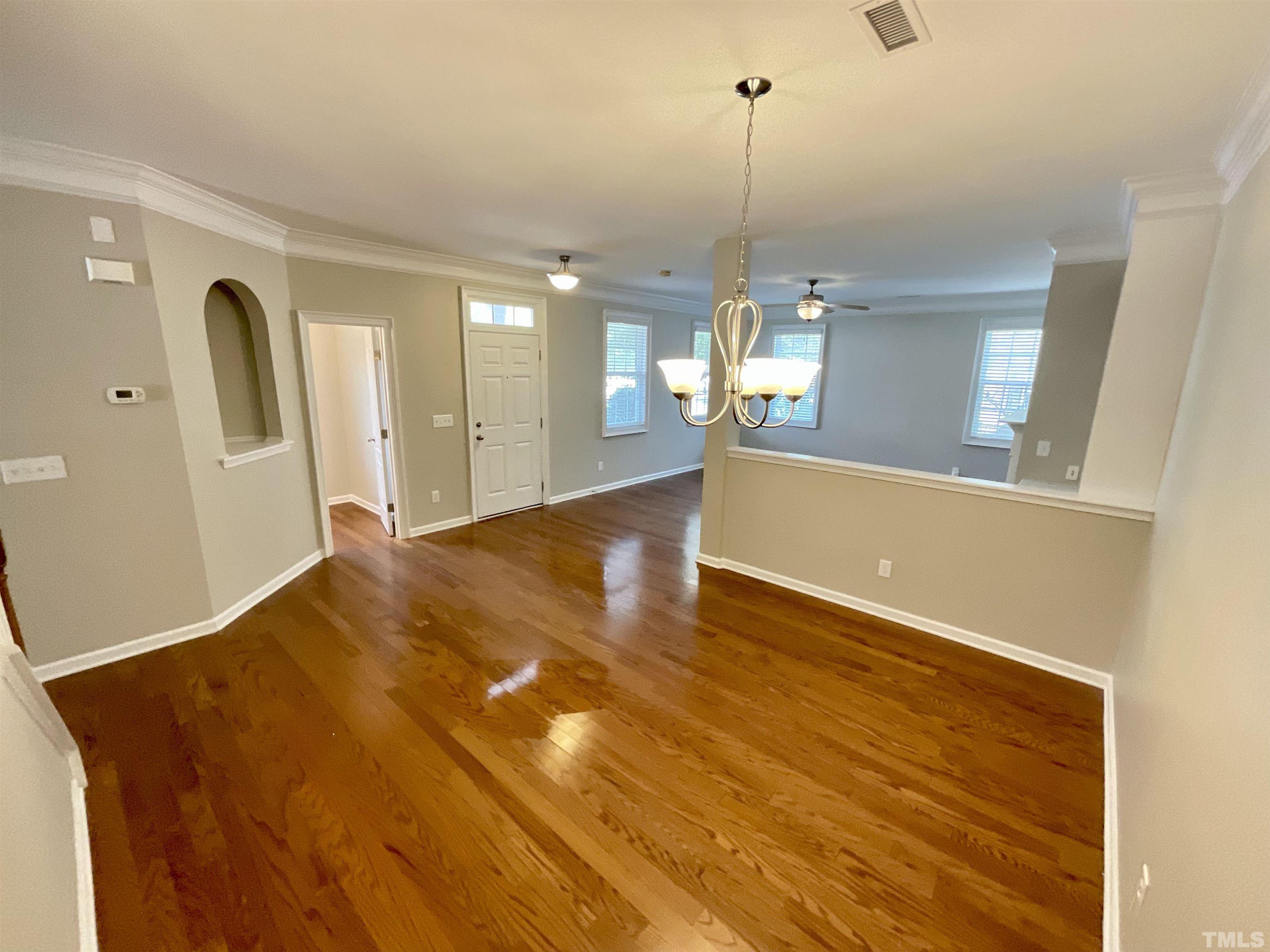2632 Cloud Mist Circle Raleigh, NC 27614 - Photo 22 of 25 a view of a living room with kitchen island a sink wooden floor and living room view