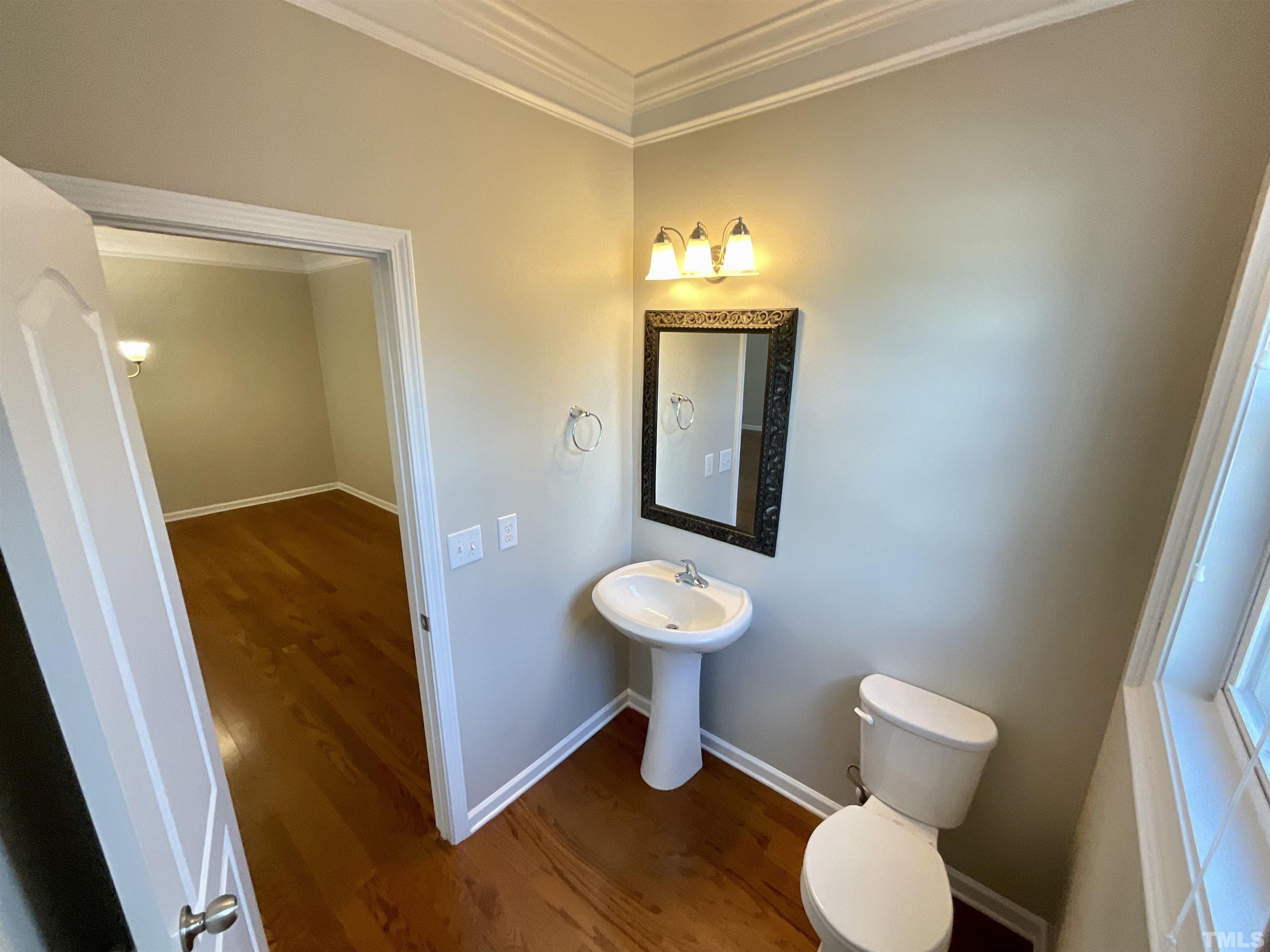2632 Cloud Mist Circle Raleigh, NC 27614 - Photo 23 of 25 a bathroom with a toilet sink and a mirror