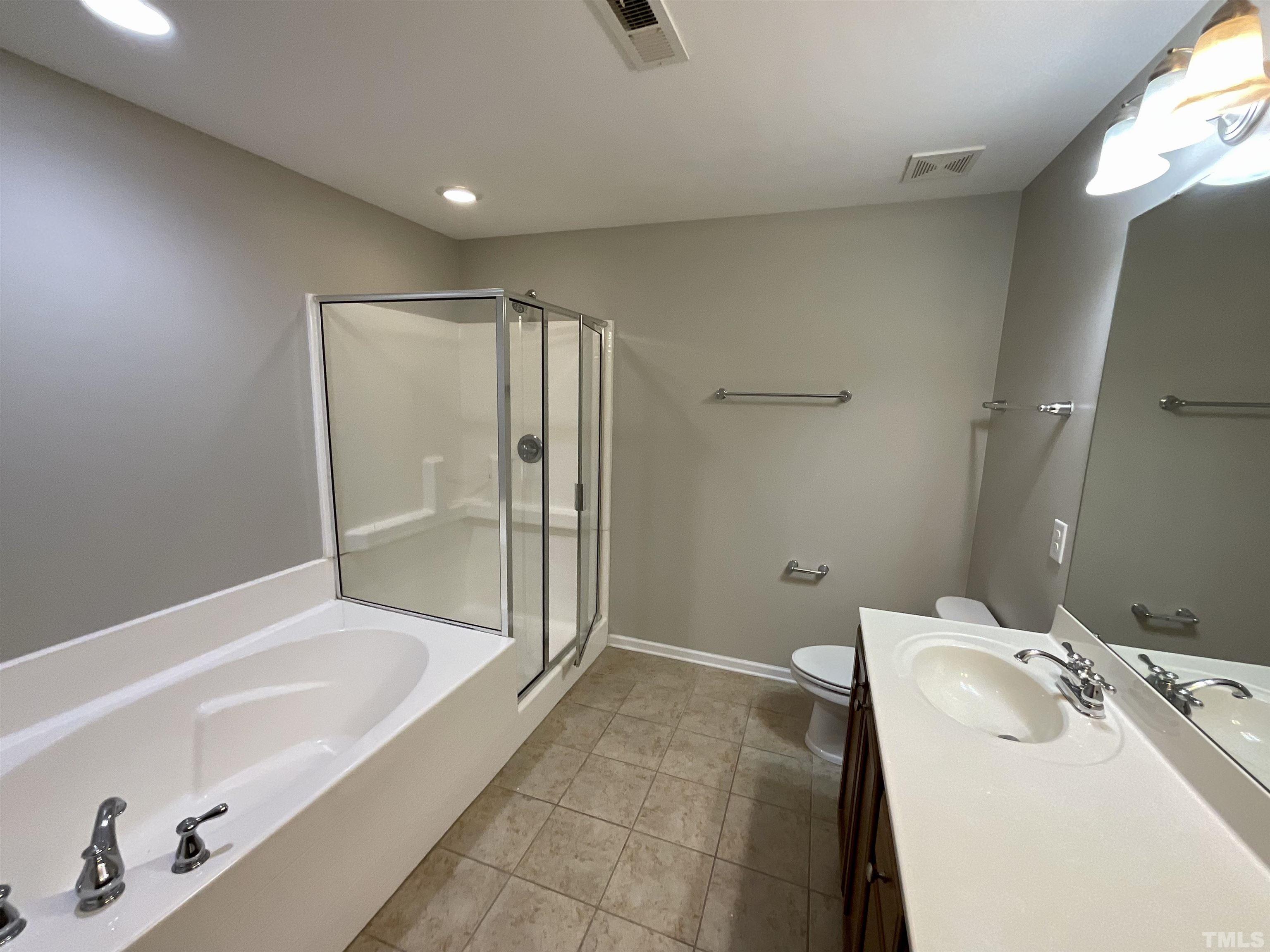 2632 Cloud Mist Circle Raleigh, NC 27614 - Photo 6 of 25 a bathroom with a tub a sink and mirror