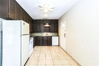 a kitchen with a refrigerator stove and microwave