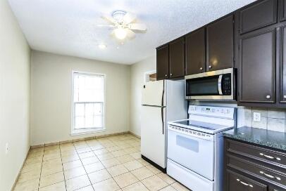 2711 22nd Street Lubbock, TX 79410 - Photo 13 of 28 a kitchen with a refrigerator stove and microwave