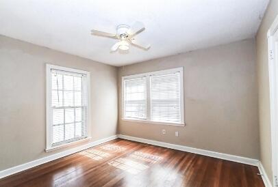 2711 22nd Street Lubbock, TX 79410 - Photo 14 of 28 a view of an empty room with a window and wooden floor