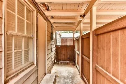 a view of backyard with small cabin and wooden fence