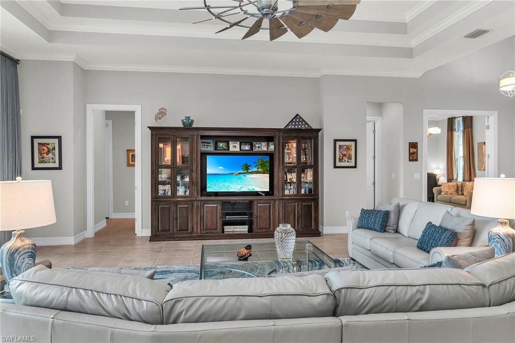 14812 Dockside Lane Naples, FL 34114 - Photo 11 of 49 a living room with furniture and a flat screen tv
