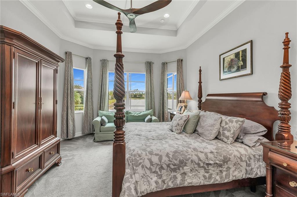 14812 Dockside Lane Naples, FL 34114 - Photo 17 of 49 a bedroom with a large bed and a chandelier