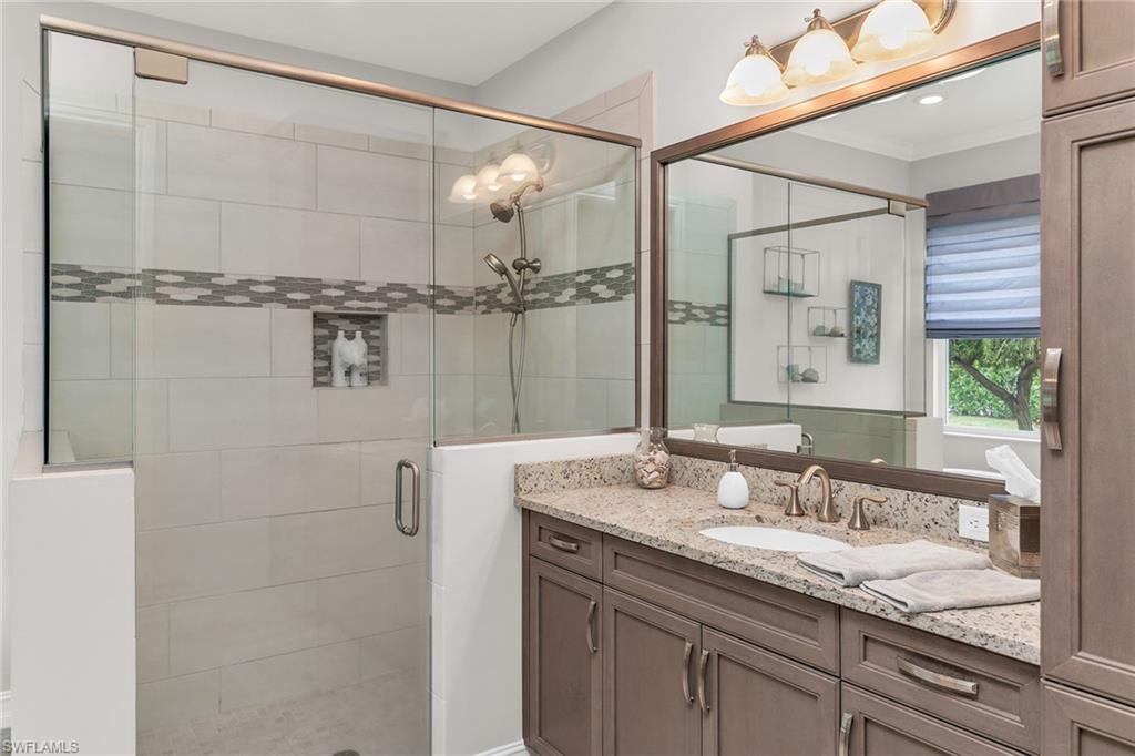 14812 Dockside Lane Naples, FL 34114 - Photo 20 of 49 a bathroom with a granite countertop sink and a mirror