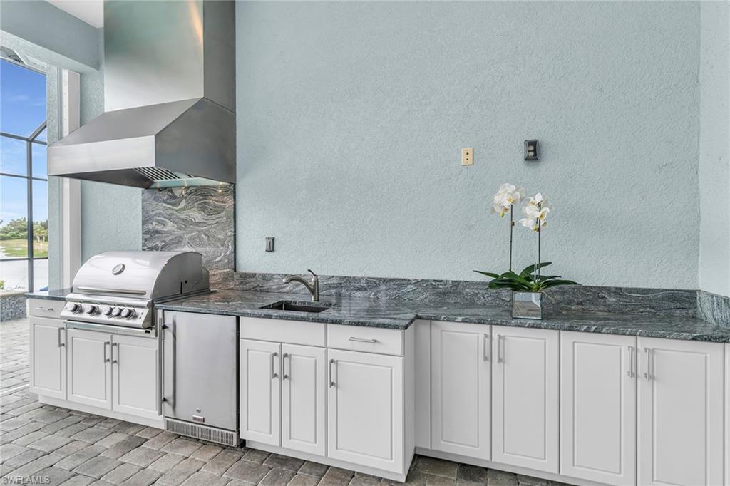 14812 Dockside Lane Naples, FL 34114 - Photo 29 of 49 a kitchen with stainless steel appliances granite countertop a sink and cabinets