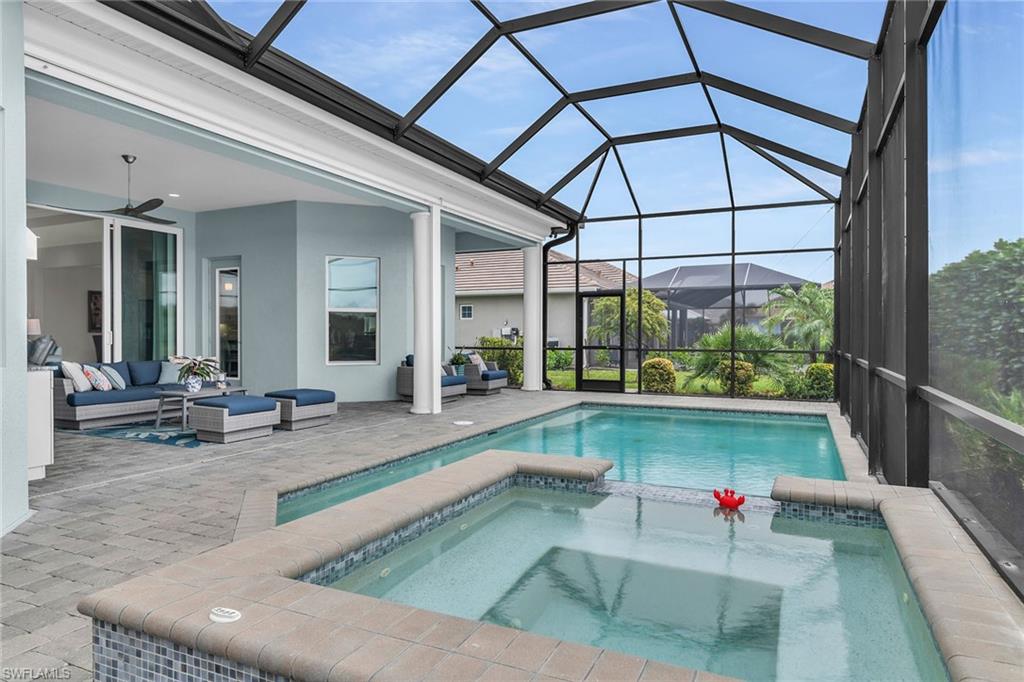 14812 Dockside Lane Naples, FL 34114 - Photo 34 of 49 a view of swimming pool with outdoor seating