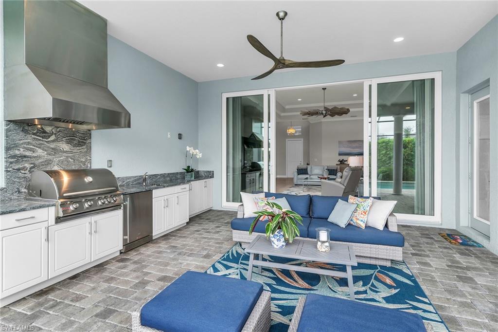 14812 Dockside Lane Naples, FL 34114 - Photo 35 of 49 a living room with stainless steel appliances granite countertop furniture a rug kitchen view and a chandelier