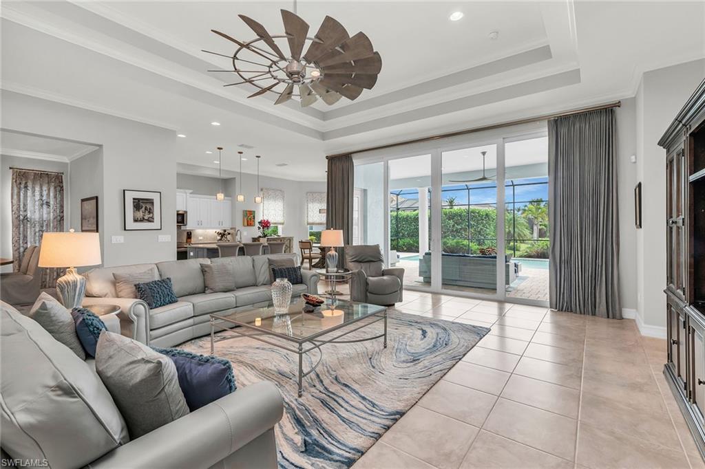 14812 Dockside Lane Naples, FL 34114 - Photo 4 of 49 a living room with furniture and a large window