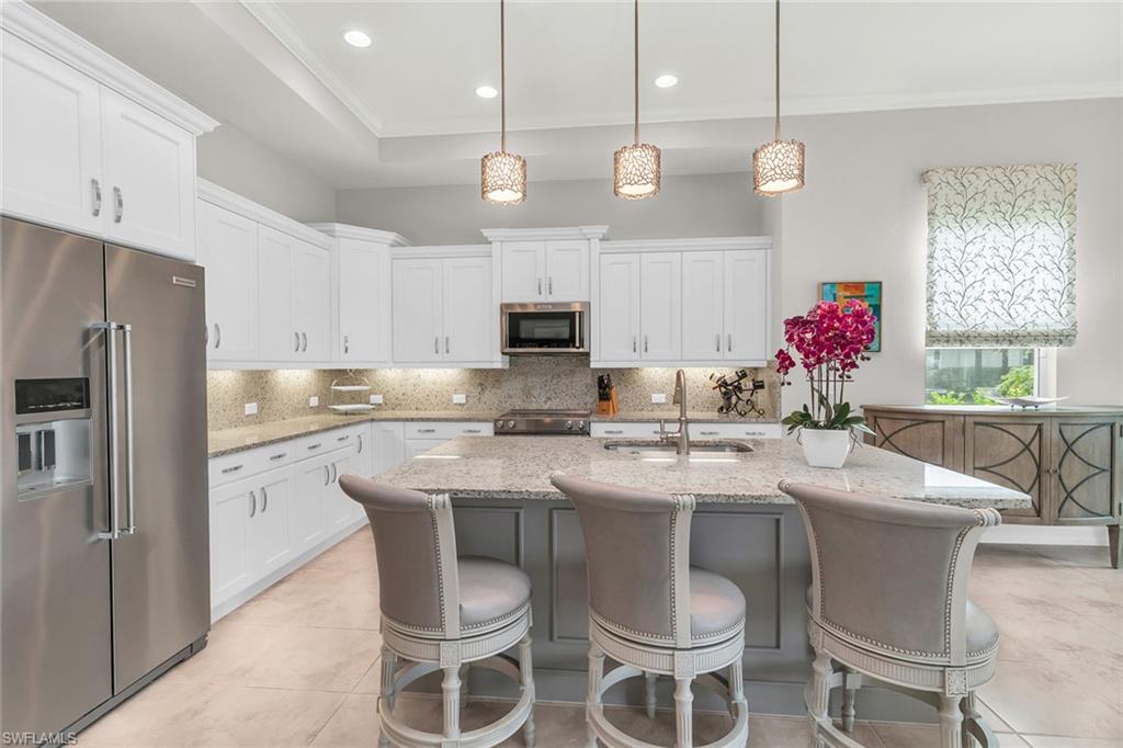 14812 Dockside Lane Naples, FL 34114 - Photo 5 of 49 a kitchen with a sink stove and microwave