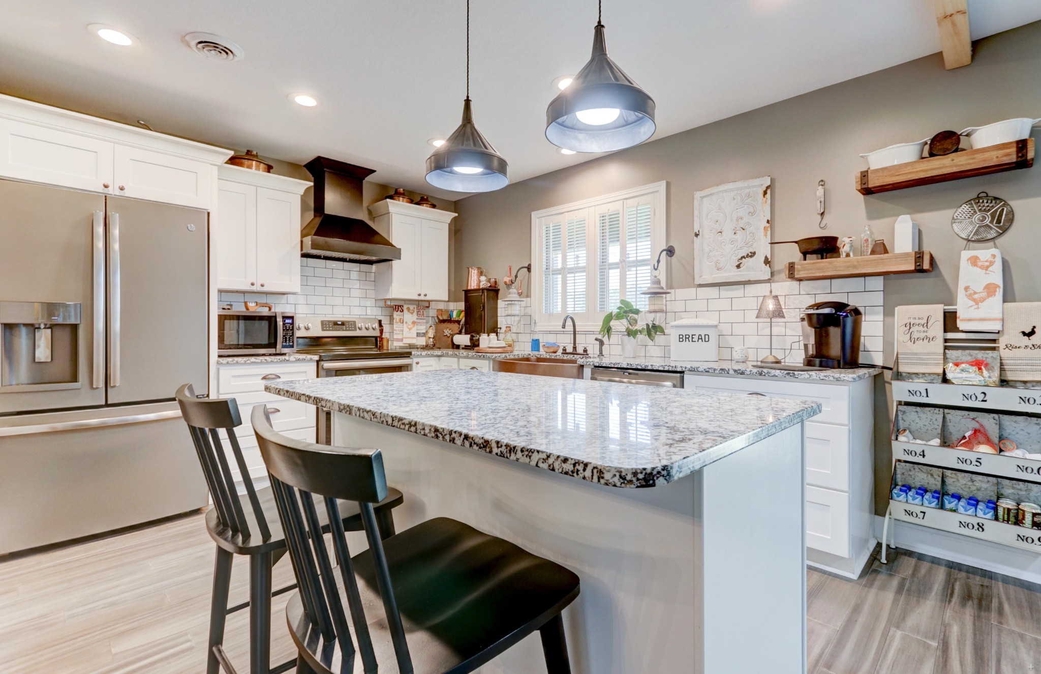 7429 Lakeshore Drive Rutledge, TN 37861 - Photo 5 of 38 a kitchen with stainless steel appliances granite countertop a stove top oven a sink a dining table and chairs with wooden floor