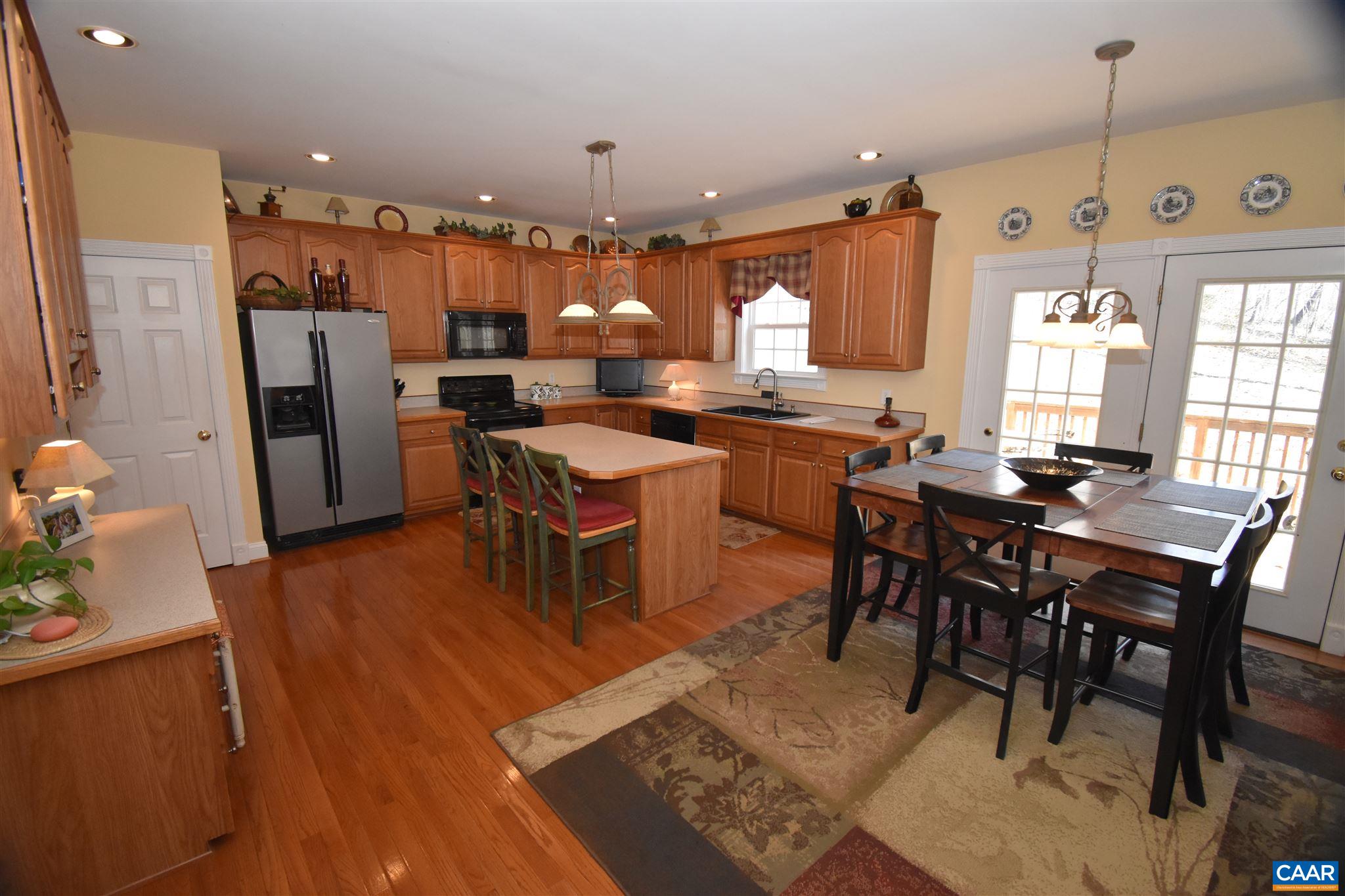 285 March Road Stanardsville, VA 22973 - Photo 14 of 75 a dining hall with stainless steel appliances kitchen island granite countertop furniture a dining table and chairs