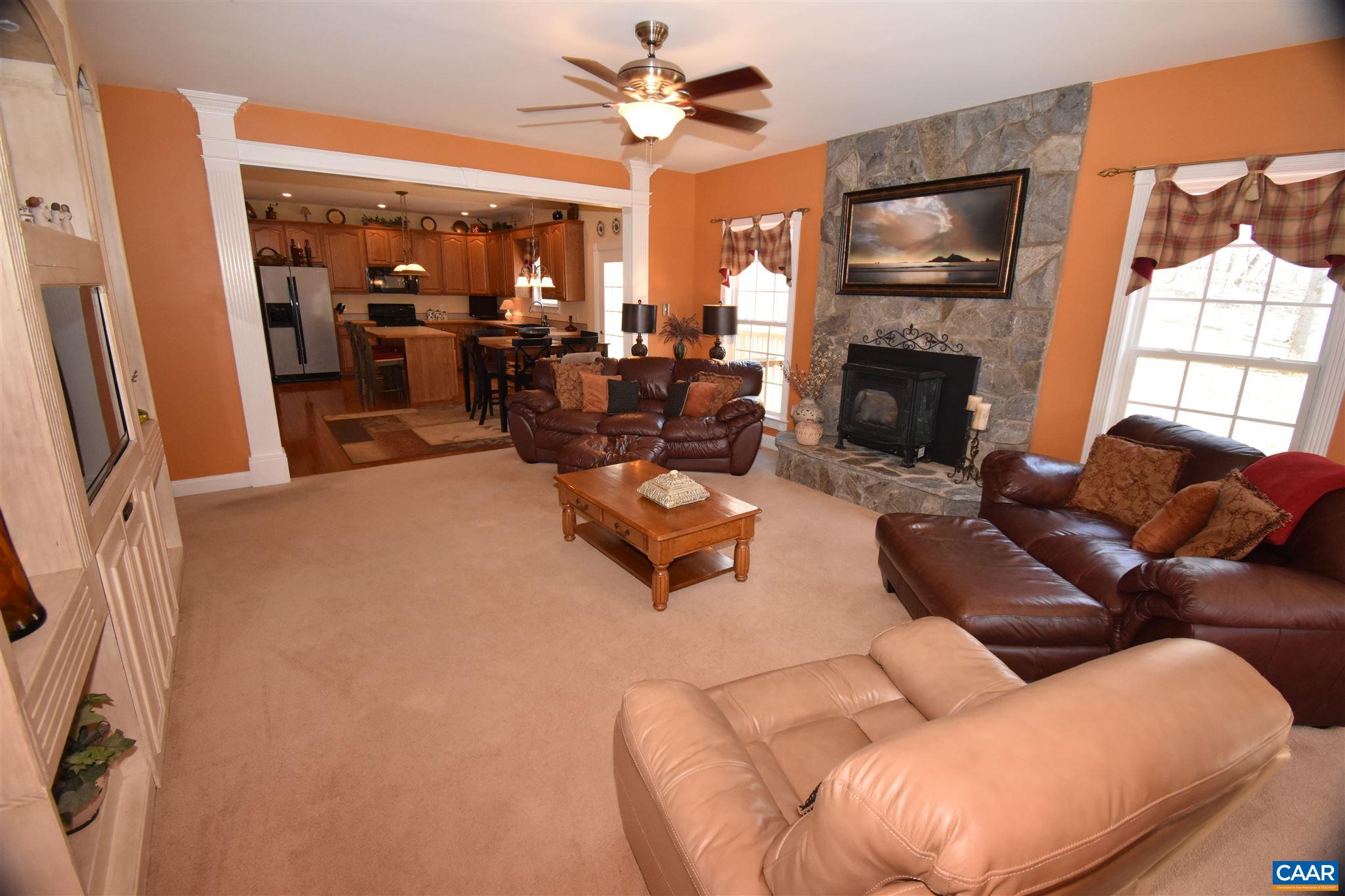 285 March Road Stanardsville, VA 22973 - Photo 20 of 75 a living room with furniture a fireplace and a flat screen tv