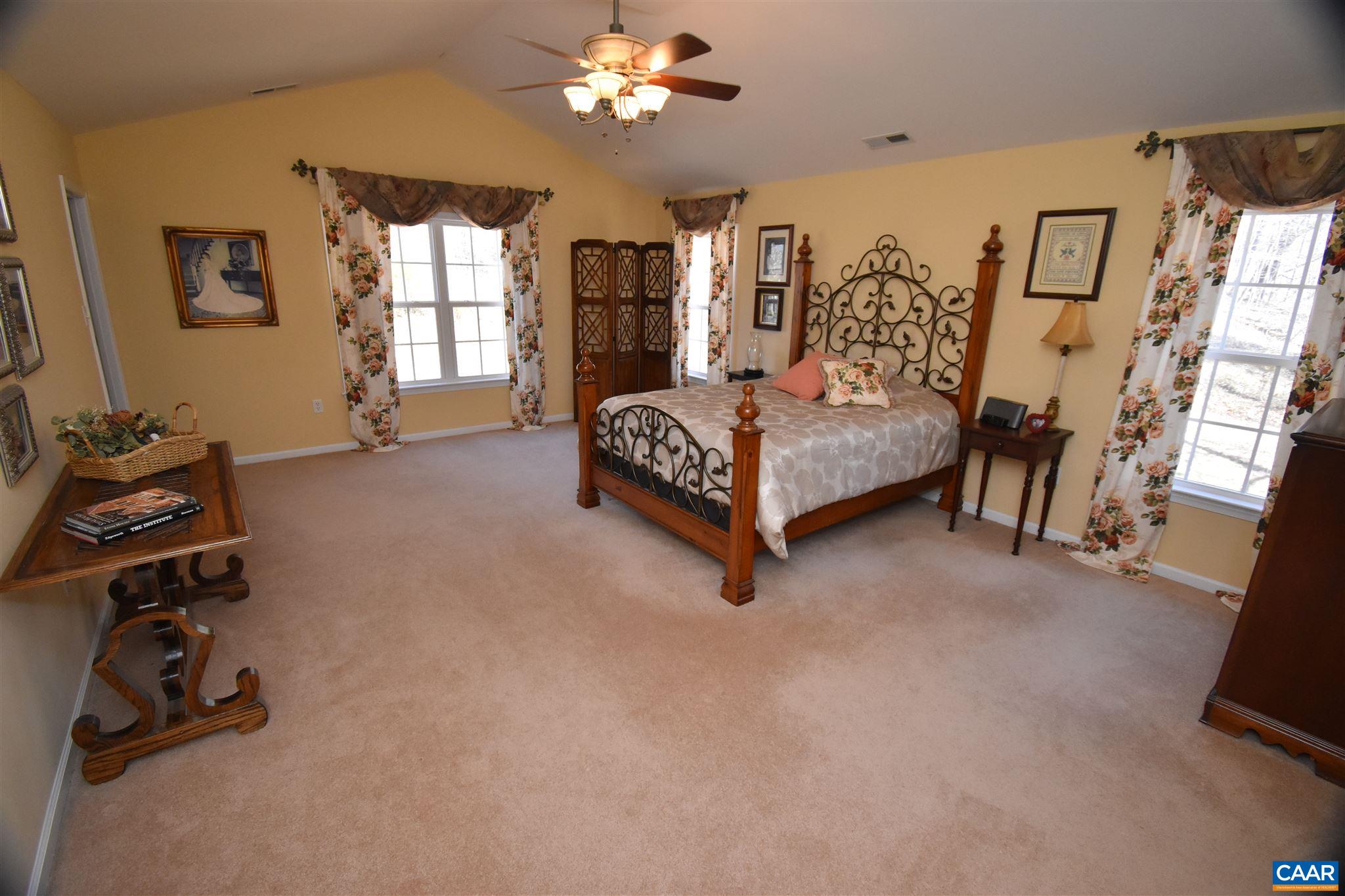 285 March Road Stanardsville, VA 22973 - Photo 30 of 75 a bedroom with a bed gym equipment and a large mirror