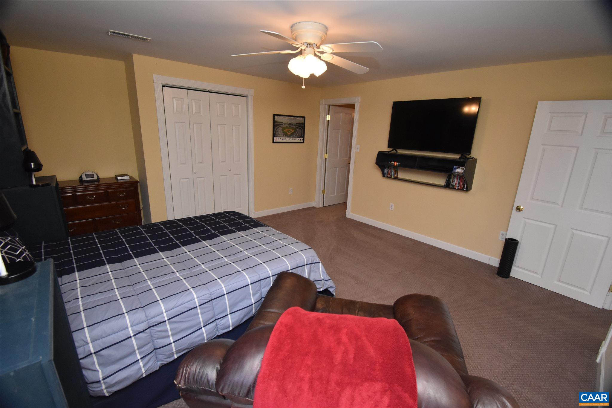 285 March Road Stanardsville, VA 22973 - Photo 44 of 75 a bedroom with a bed and a flat screen tv