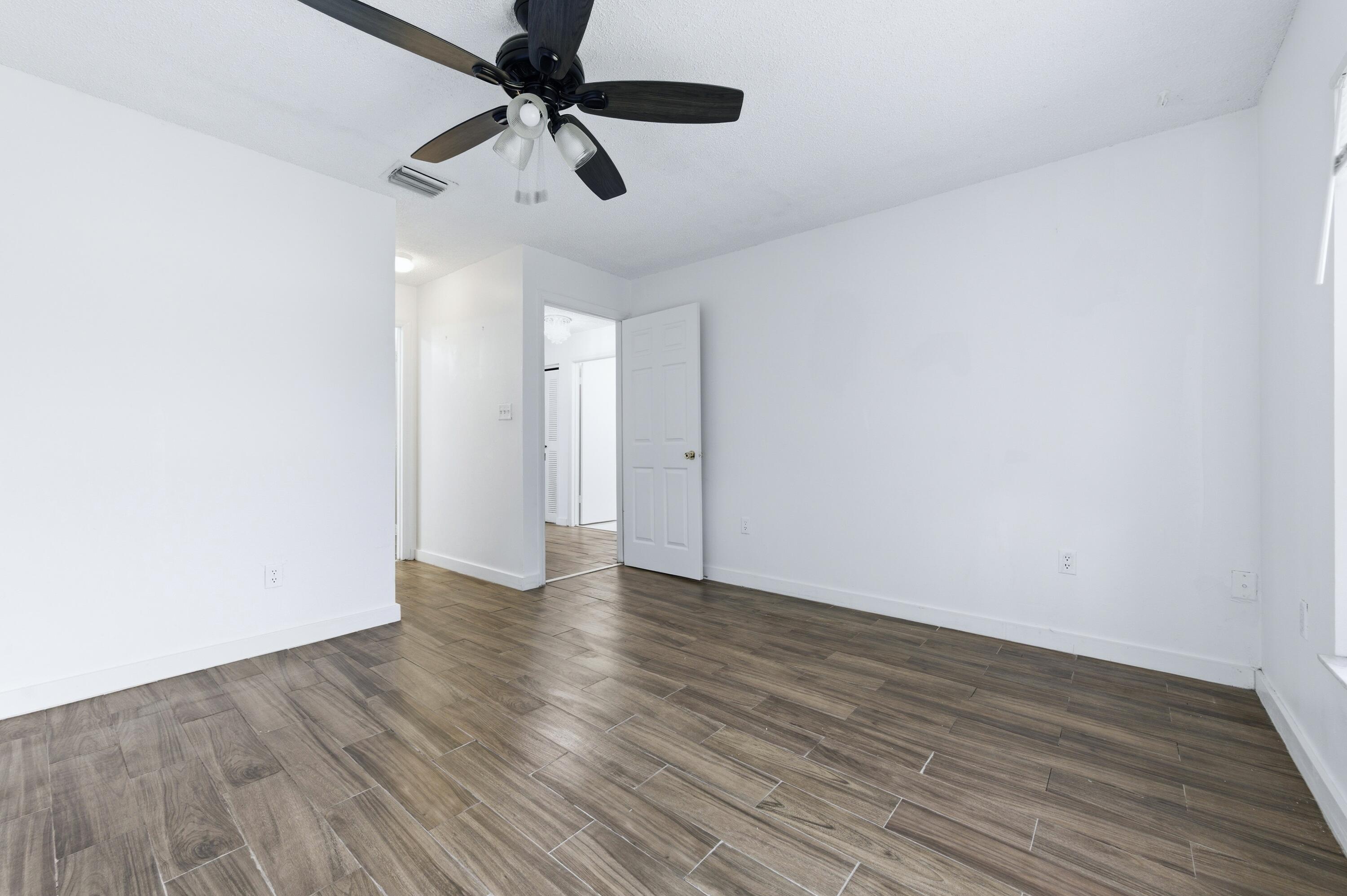6088 Heather Street Jupiter, FL 33458 - Photo 10 of 18 a view of an empty room with wooden floor