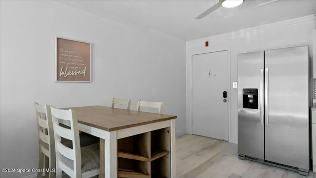 a kitchen with a table and refrigerator