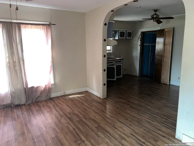 an empty room with wooden floor and a window