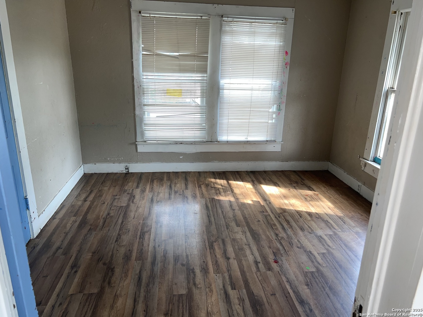 822 North High Street Uvalde, TX 78801 - Photo 10 of 14 a view of empty room with wooden floor and fan