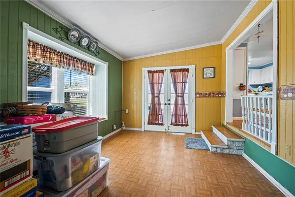 a living room with furniture a flat screen tv and large window