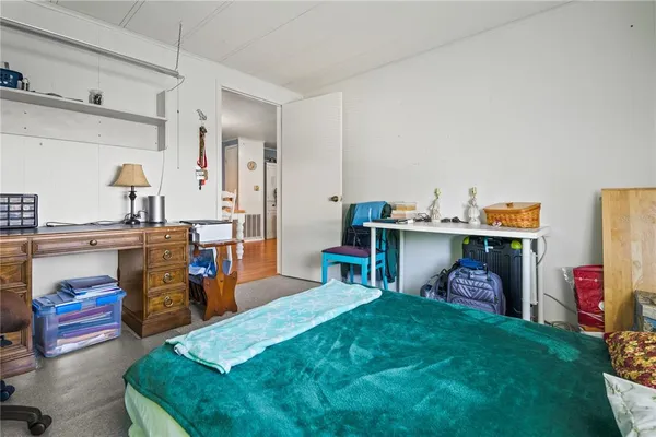 a bed room with a bed and a television