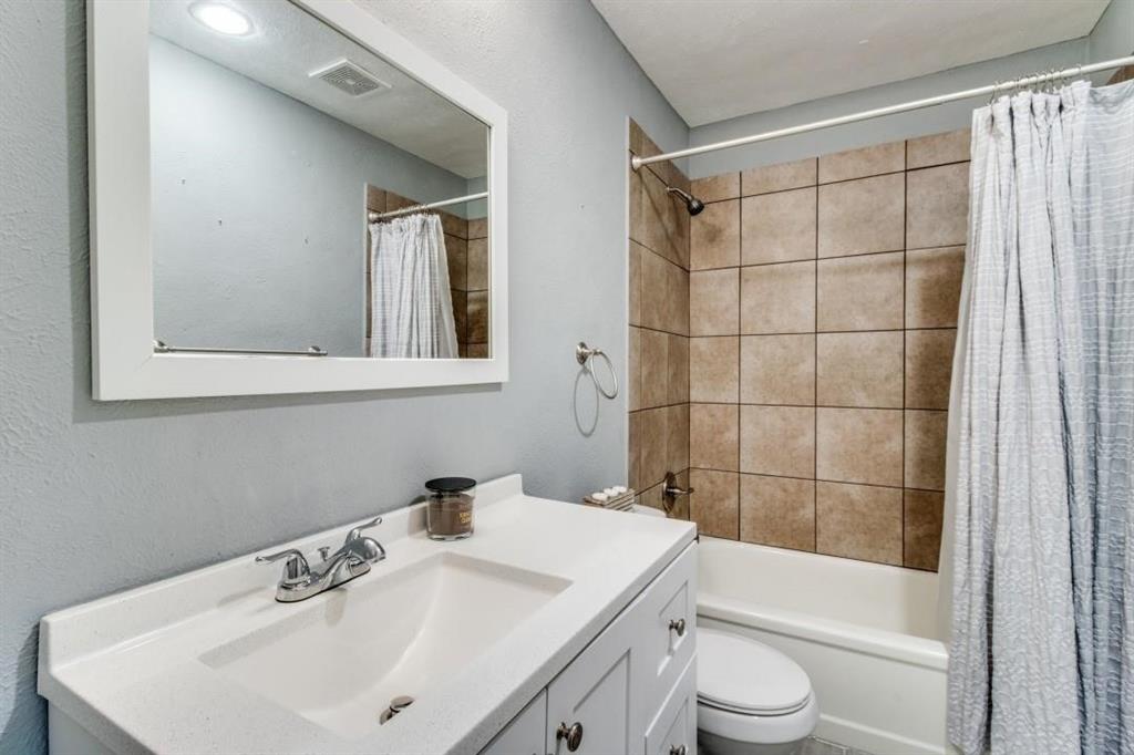 9645 Limestone Drive Dallas, TX 75217 - Photo 11 of 15 a bathroom with a sink a toilet and shower