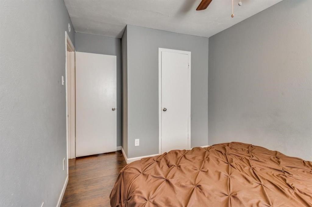 9645 Limestone Drive Dallas, TX 75217 - Photo 13 of 15 a bedroom with a bed and a mirror