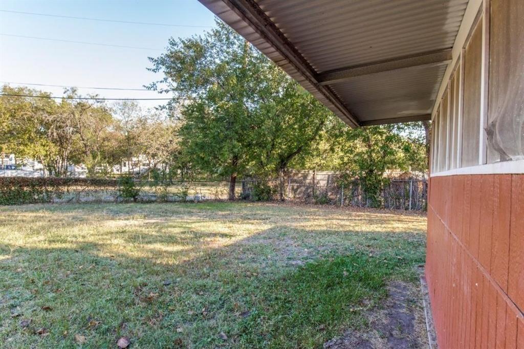 9645 Limestone Drive Dallas, TX 75217 - Photo 14 of 15 a view of a yard with large trees