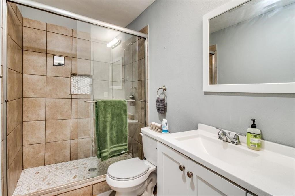 9645 Limestone Drive Dallas, TX 75217 - Photo 8 of 15 a bathroom with a sink a toilet and shower