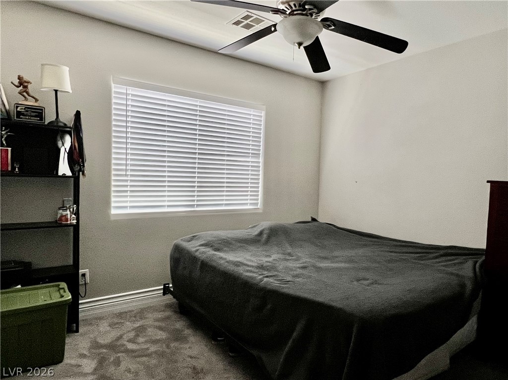 151 Short Ruff Way Las Vegas, NV 89148 - Photo 5 of 17 A single window provides natural illumination to this carpeted room.