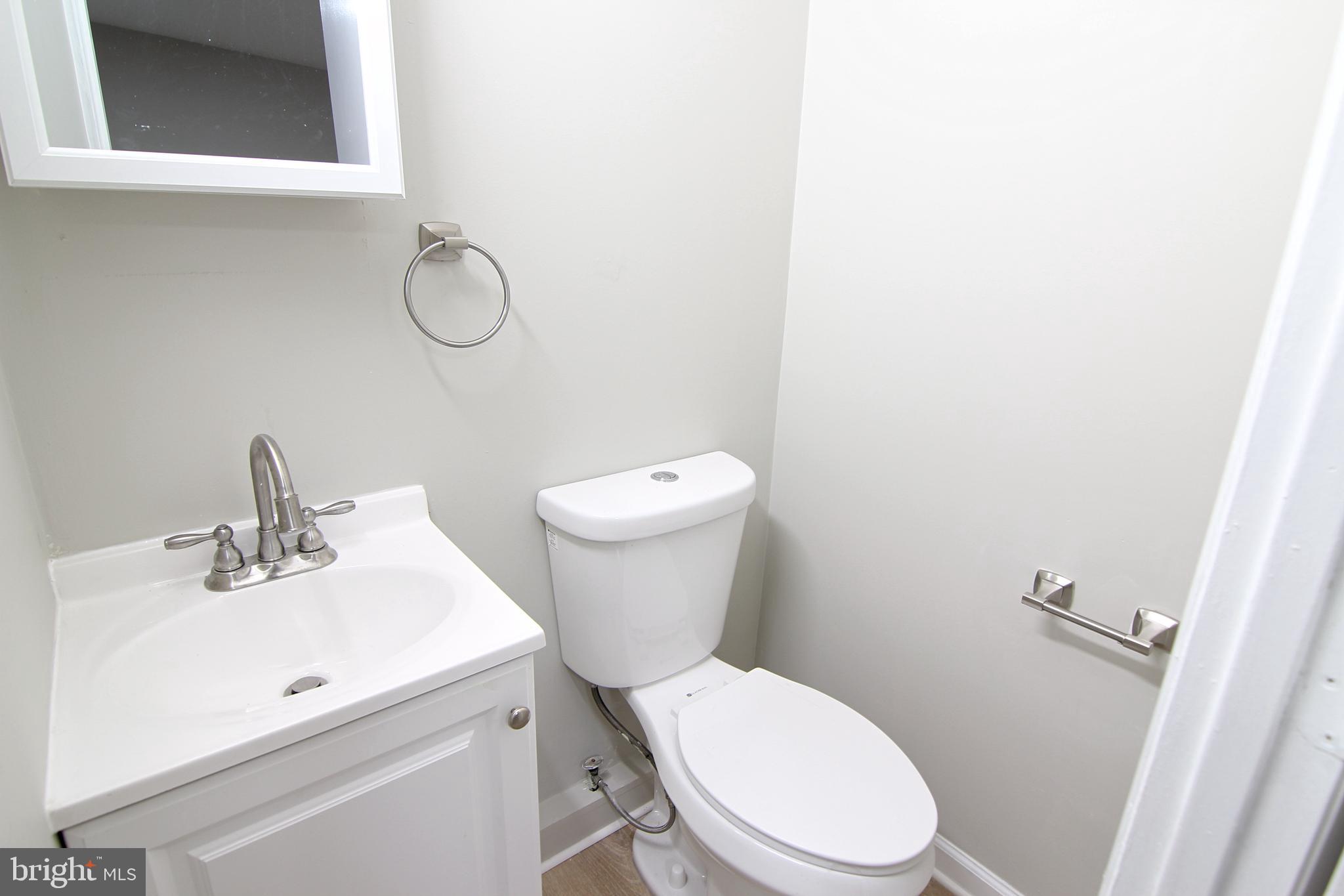 617 Ford Street, Unit 2 Bridgeport, PA 19405 - Photo 11 of 11 a white toilet sitting next to a bathroom sink