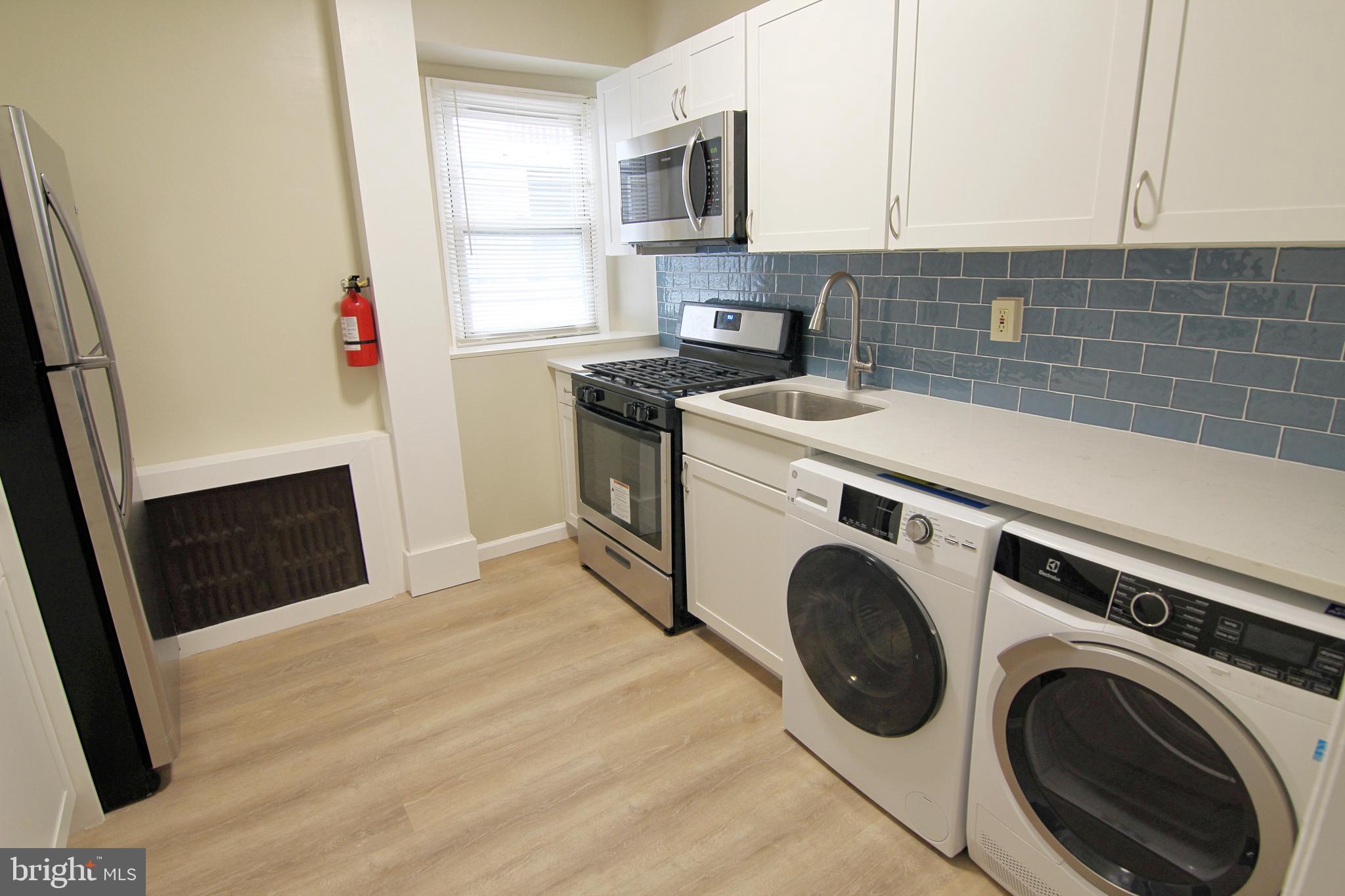 617 Ford Street, Unit 2 Bridgeport, PA 19405 - Photo 4 of 11 a view of a kitchen with washer and dryer