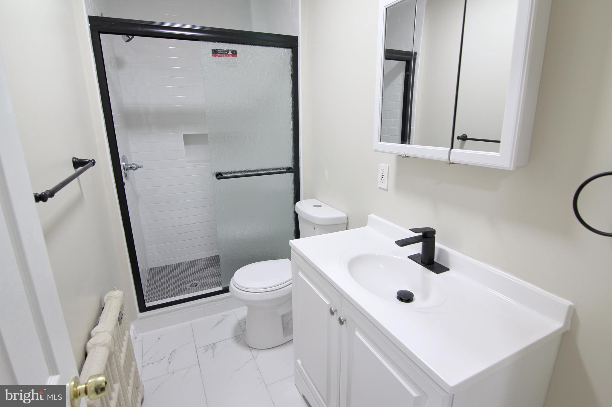 617 Ford Street, Unit 2 Bridgeport, PA 19405 - Photo 6 of 11 a bathroom with a sink a toilet and a mirror