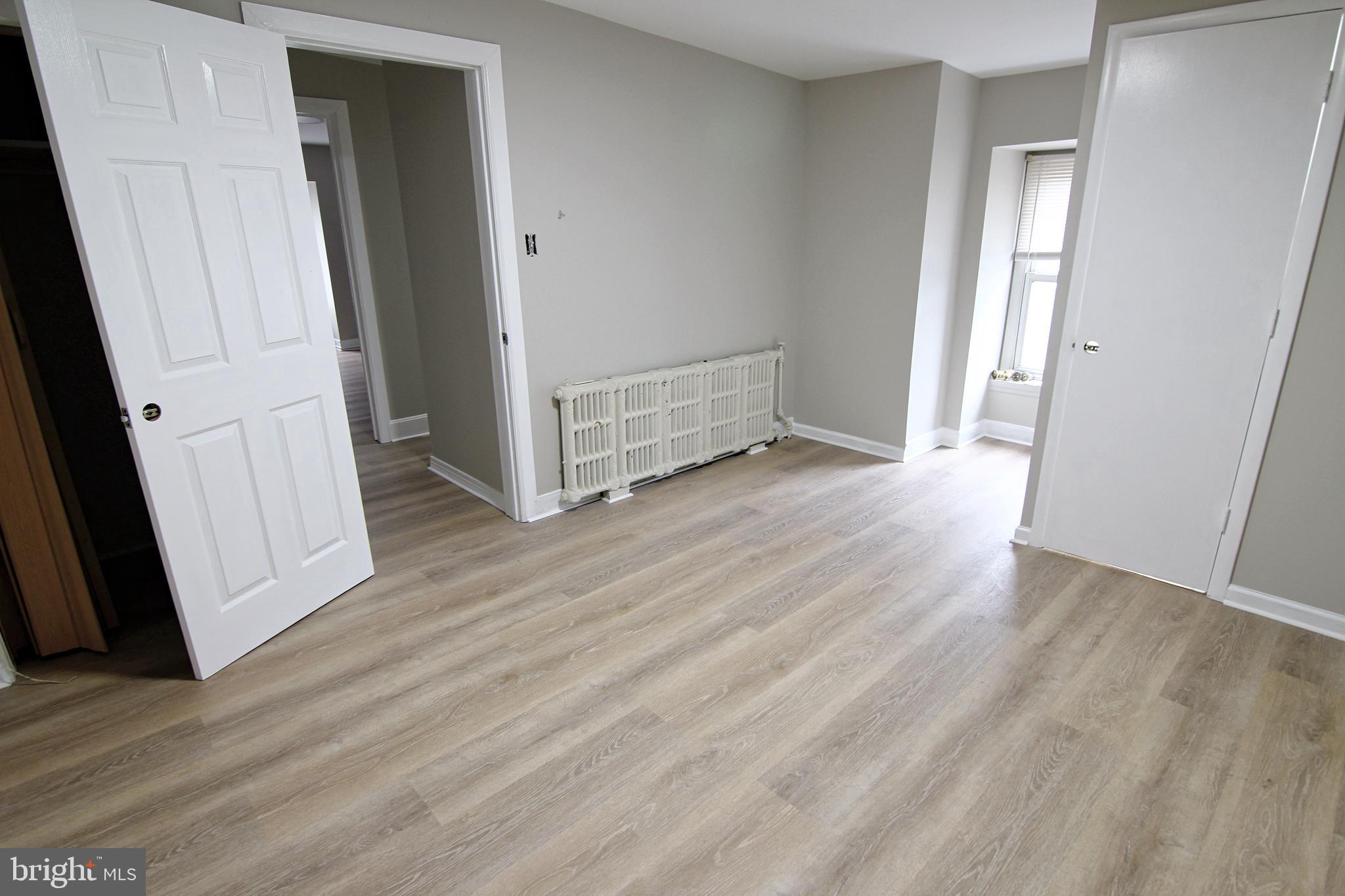 617 Ford Street, Unit 2 Bridgeport, PA 19405 - Photo 8 of 11 an empty room with wooden floor and entrance