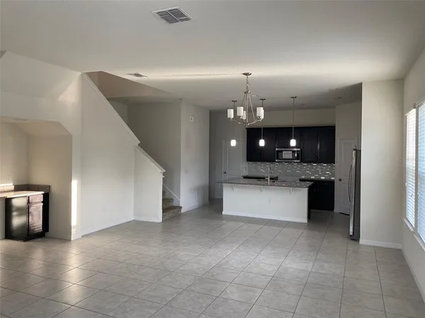 a kitchen with granite countertop a sink and refrigerator