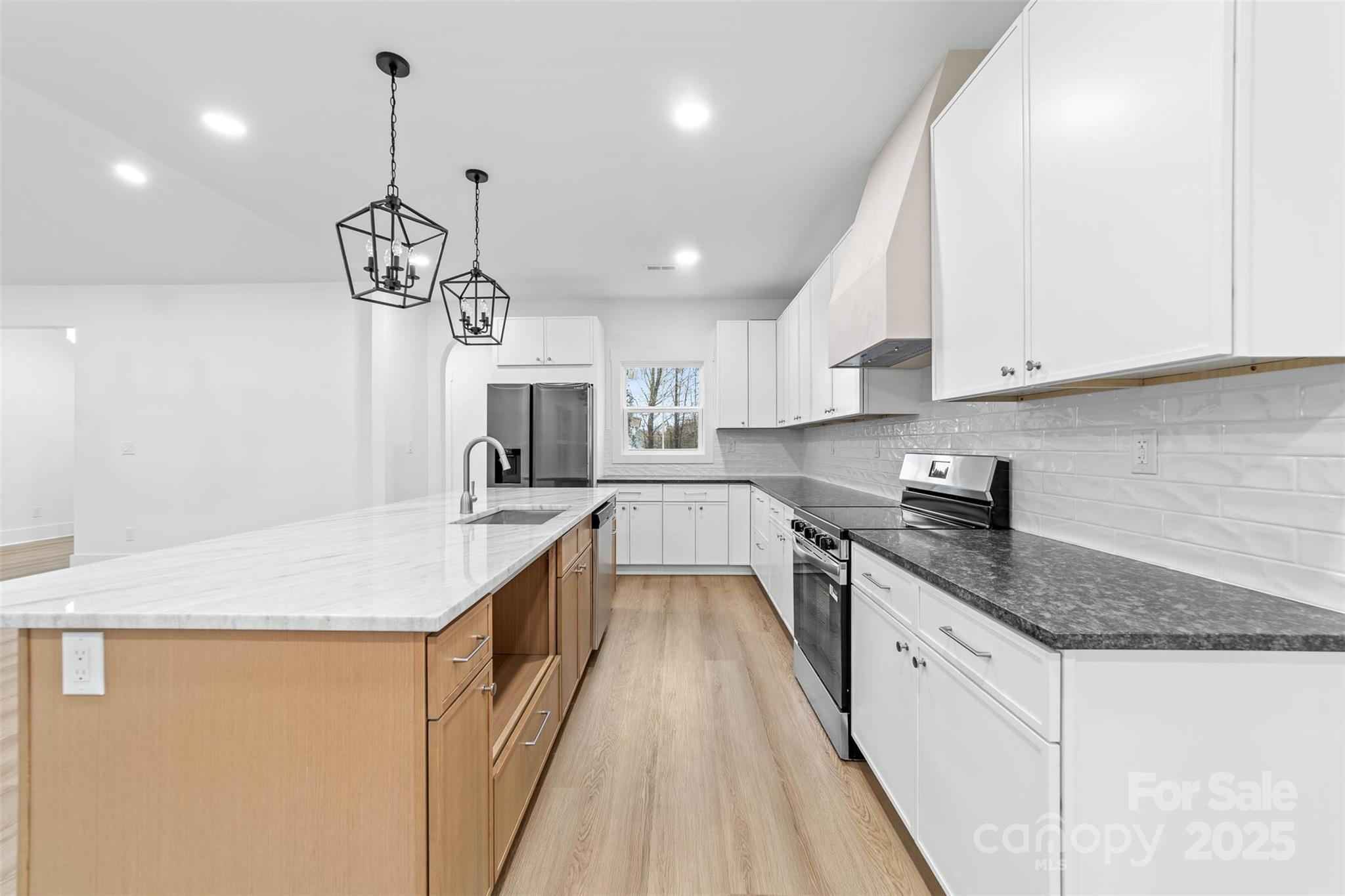 2102 Whitworth Road Cherryville, NC 28021 - Photo 11 of 34 a kitchen with a sink a counter top space stainless steel appliances and cabinets