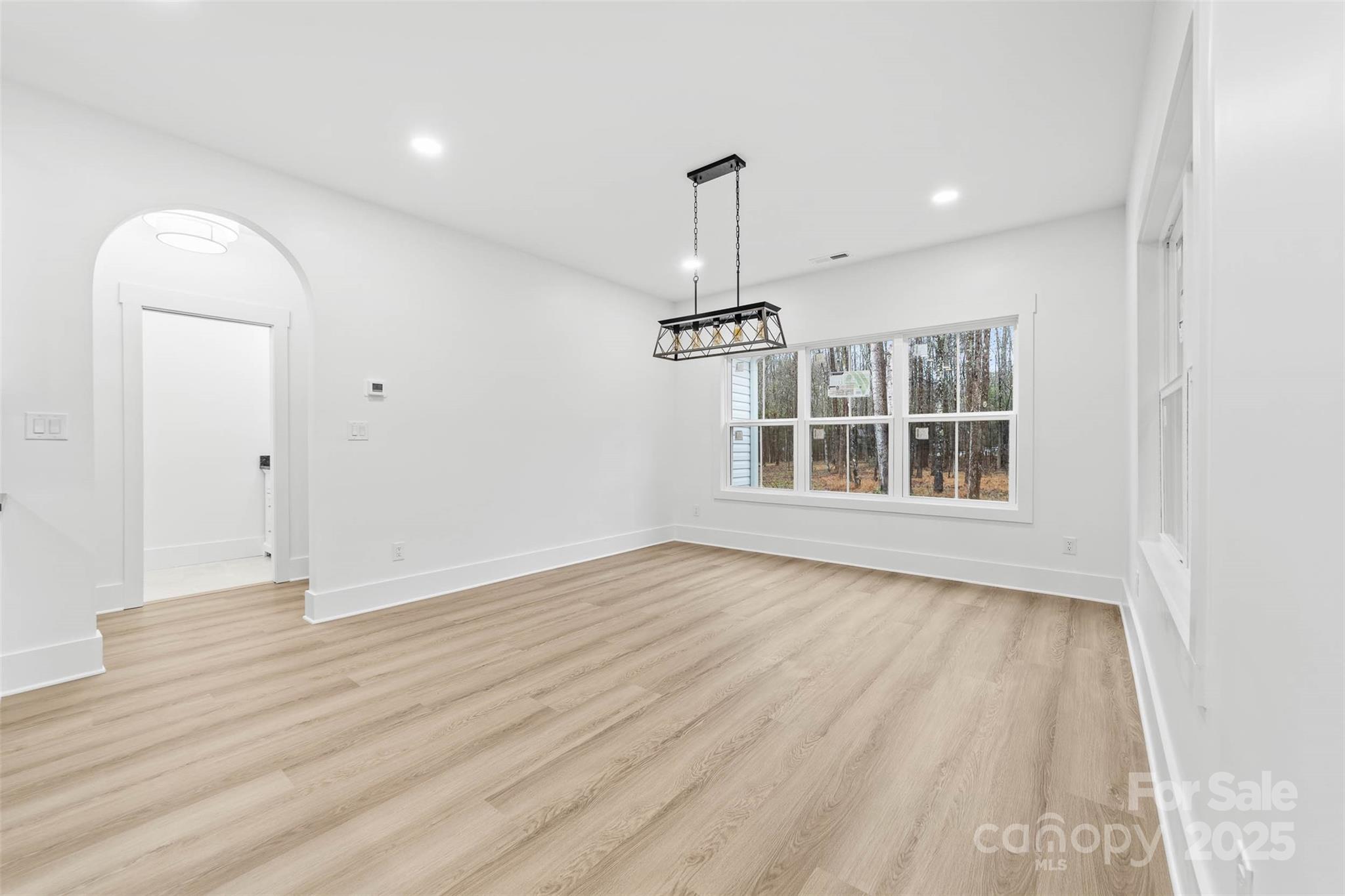 2102 Whitworth Road Cherryville, NC 28021 - Photo 16 of 34 an empty room with wooden floor cabinet and windows