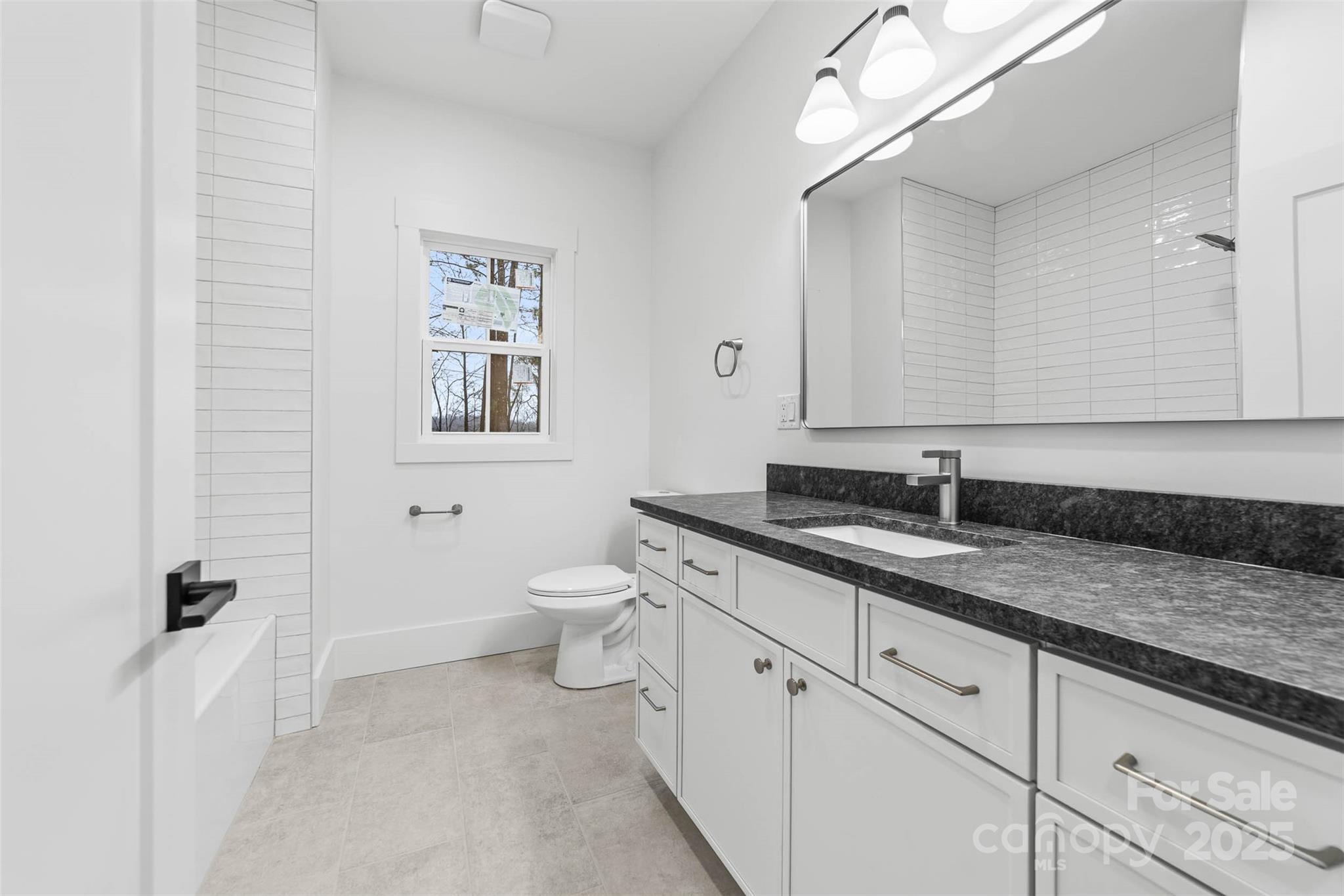 2102 Whitworth Road Cherryville, NC 28021 - Photo 4 of 34 a bathroom with a granite countertop sink mirror and toilet
