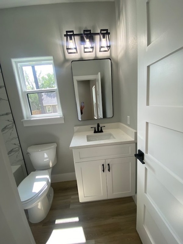 116 Field Street Luling, TX 78648 - Photo 21 of 33 A well-lit bathroom with a bright window, sleek vanity, and modern fixtures.