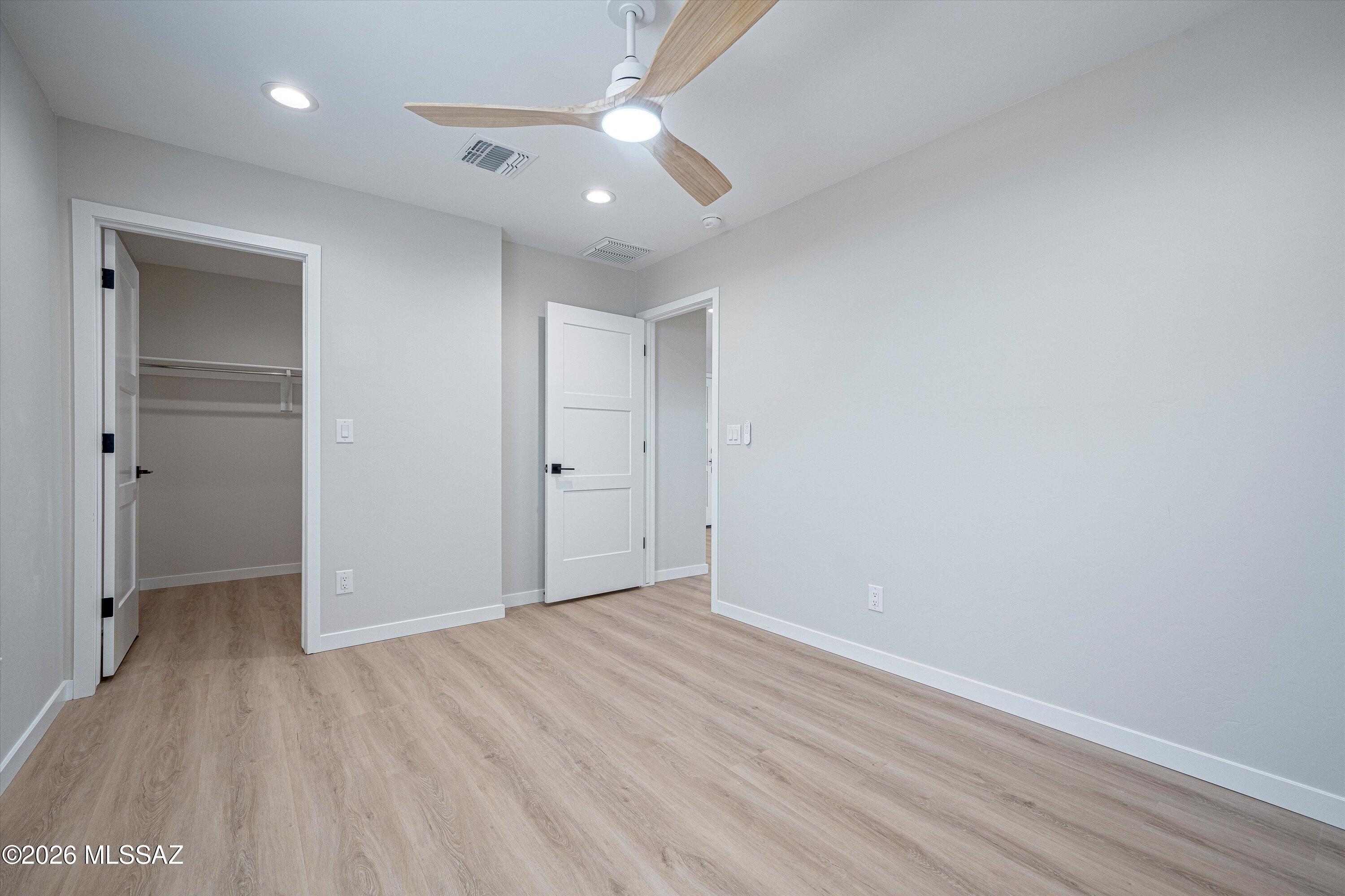 739 North Queen Avenue, Unit 2 Tucson, AZ 85705 - Photo 17 of 28 wooden floor in an empty room with a window