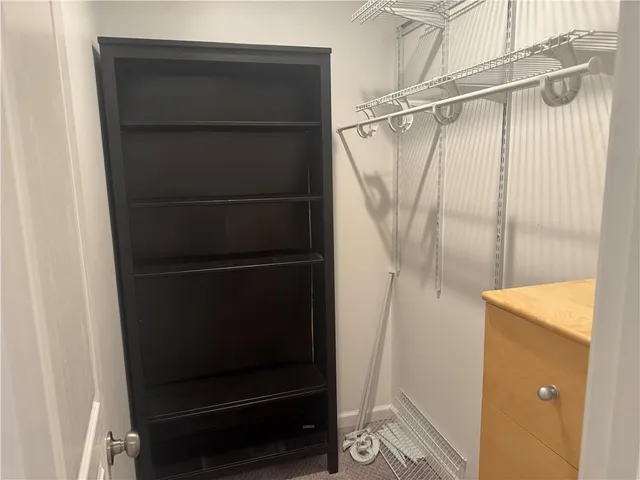 a view of a hallway with a wooden cabinets