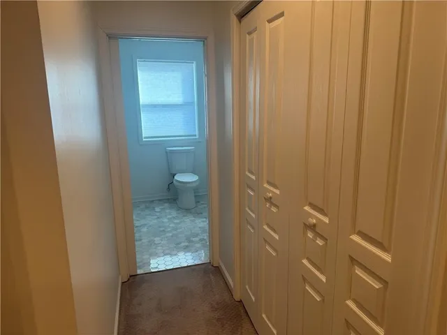 a bathroom with a toilet a sink and a window