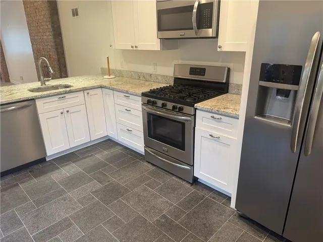 a kitchen with a sink and cabinets
