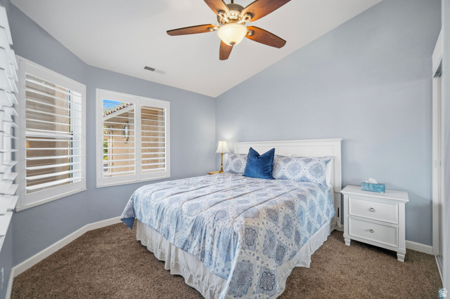 1985 West Rivers Edge Lane St. George, UT 84770 - Photo 27 of 42 Bedroom with a ceiling fan, vaulted ceiling, and dark carpet