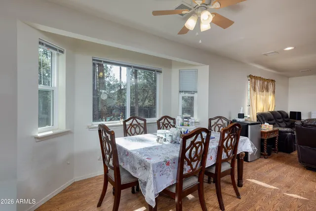 a living room with furniture kitchen view and a chandelier