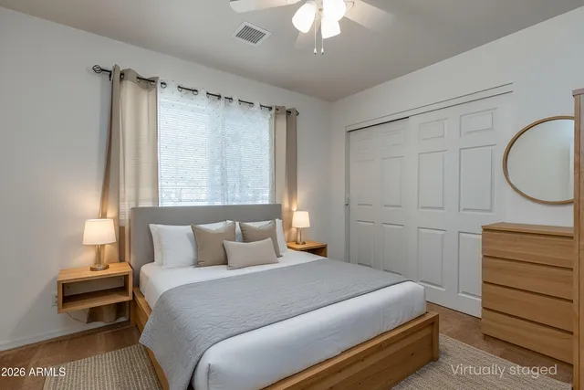 a bedroom with a large bed and a lamp